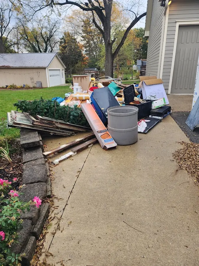 Dumpster being loaded with debris for Estate Cleanout Dumpster Rental in Brookhaven
